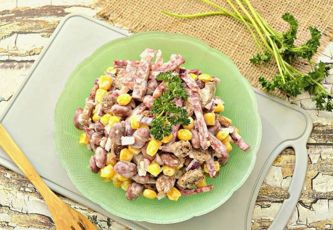 Салат с фасолью, копченой колбасой, кукурузой и сухариками