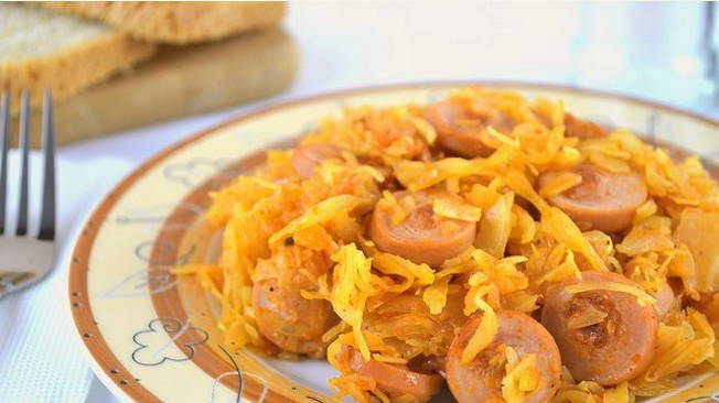 Тушеная капуста с сосисками в кастрюле