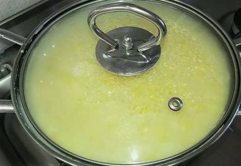 Пшенная каша с тыквой в кастрюле на газовой плите Пшенная каша с тыквой в кастрюле на газовой плите