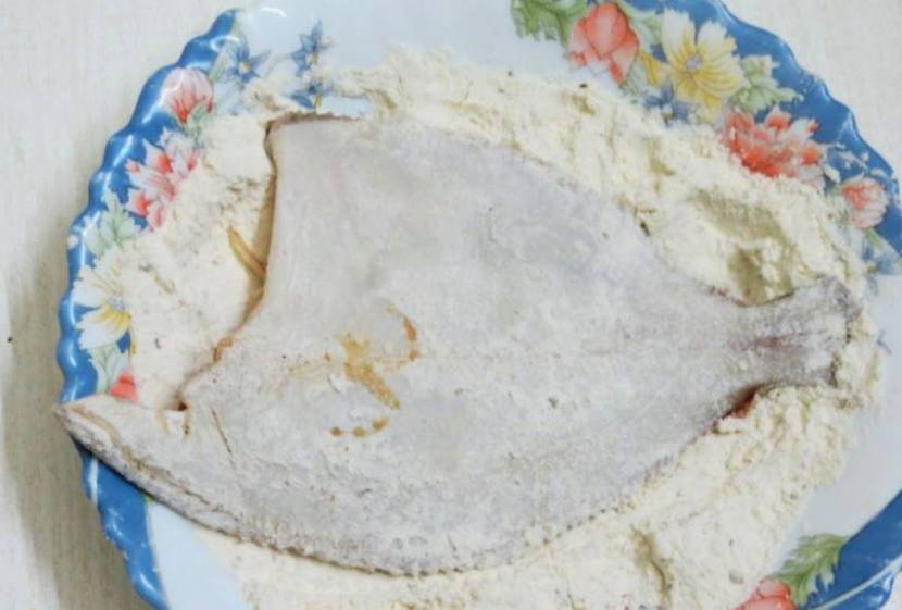 Камбала с луком и морковью на сковороде
